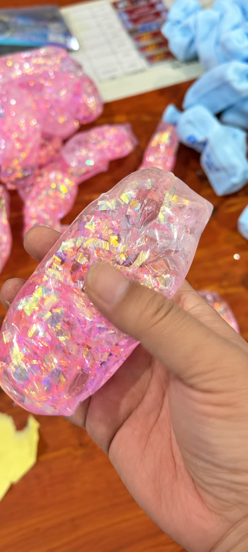 Transparent pink glitter Vaseline Butter Squishy being squeezed